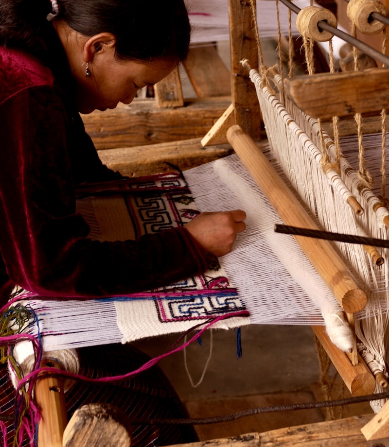 Mim at the loom in the textile corner